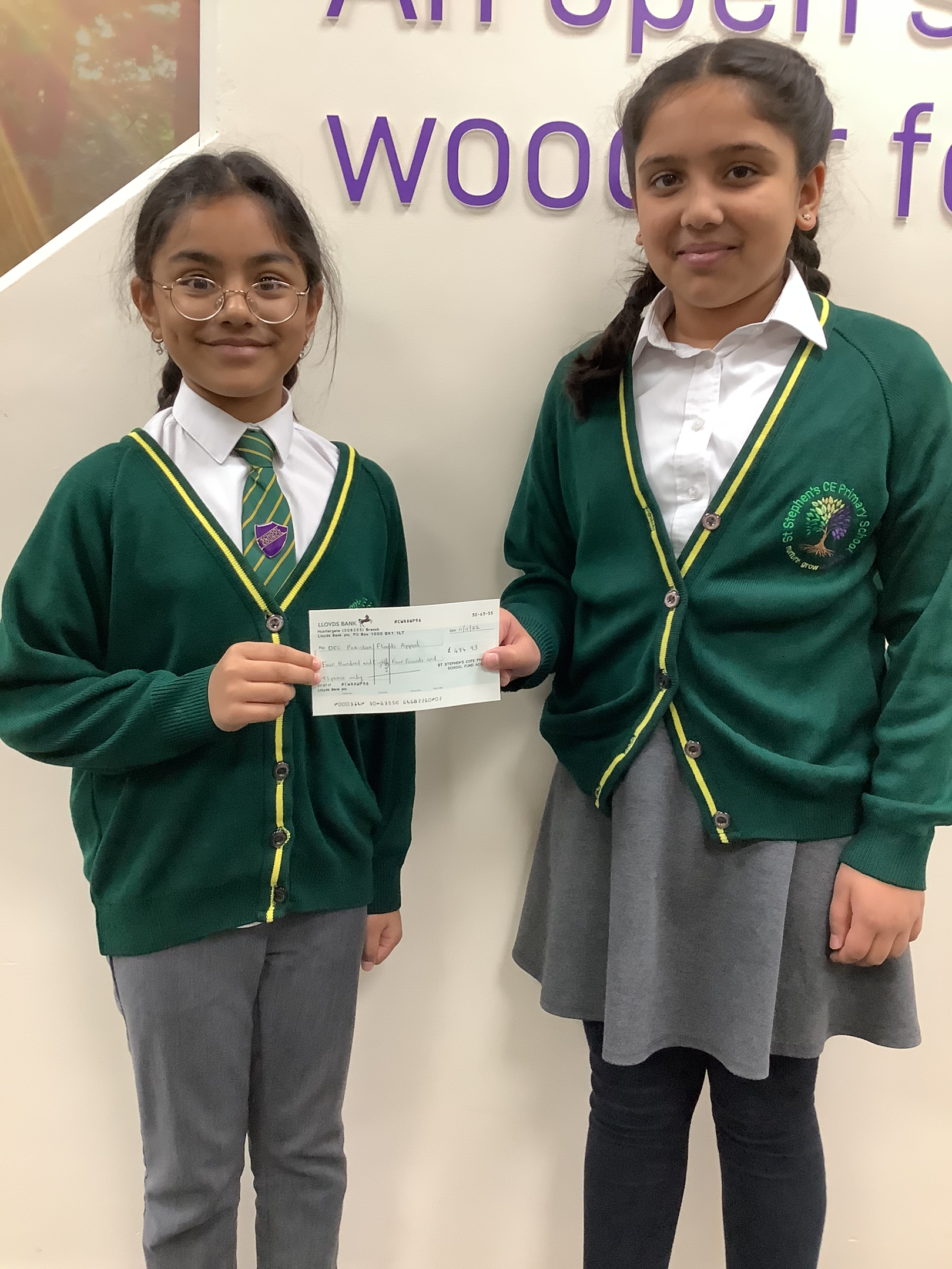 image of pupils with check for our school funds raised for the Pakistan floods.